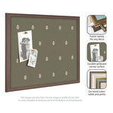 Rectangular green canvas pinboard with a small repeating white botanical leaf pattern and dark brown frame, holding two black and white photos pinned with wooden pushpins.