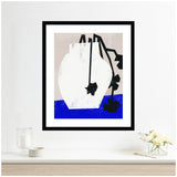 Abstract white vase with two black geometric flowers, one hanging down, set against a muted beige background and a bright blue surface in a black frame.