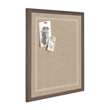 Rectangular beige fabric pinboard with a white scalloped edge pattern and a dark wooden frame, displaying two black-and-white photos pinned with wooden pushpins.