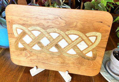 Cherry wood charcuterie board with white oak and maple Celtic knot inlay by Fitzgerald Custom Woodcraft