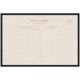 Framed linen-textured vintage postcard with faint brown text and lines dividing address and message sections, in a thin black frame.