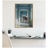Large elephant walking inside a blue-painted classical corridor with white columns and detailed ceiling moldings, framed in natural wood above a modern desk.