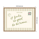 Framed vintage postcard print with beige vertical stripes and green cursive text reading "it feels so good to be home" with a pink flower postage stamp and Paris postmark.
