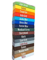 Stack of rectangular wood stain or paint samples labeled with color names, arranged vertically from lime green to white with vibrant and neutral tones.