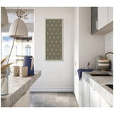 Minimalist kitchen with white cabinetry, concrete countertops, and a green botanical block print featuring a pattern of cream dots framed on the wall.