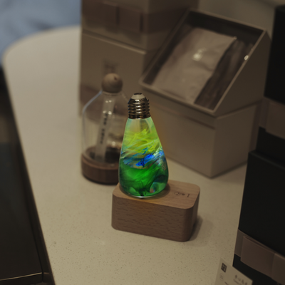 EP Light Spring Resin LED Bulb with green resin design on wooden base