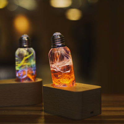 EP Light 4-Pack Resin LED Bulb Bundle showing four handcrafted resin LED bulbs and wooden base