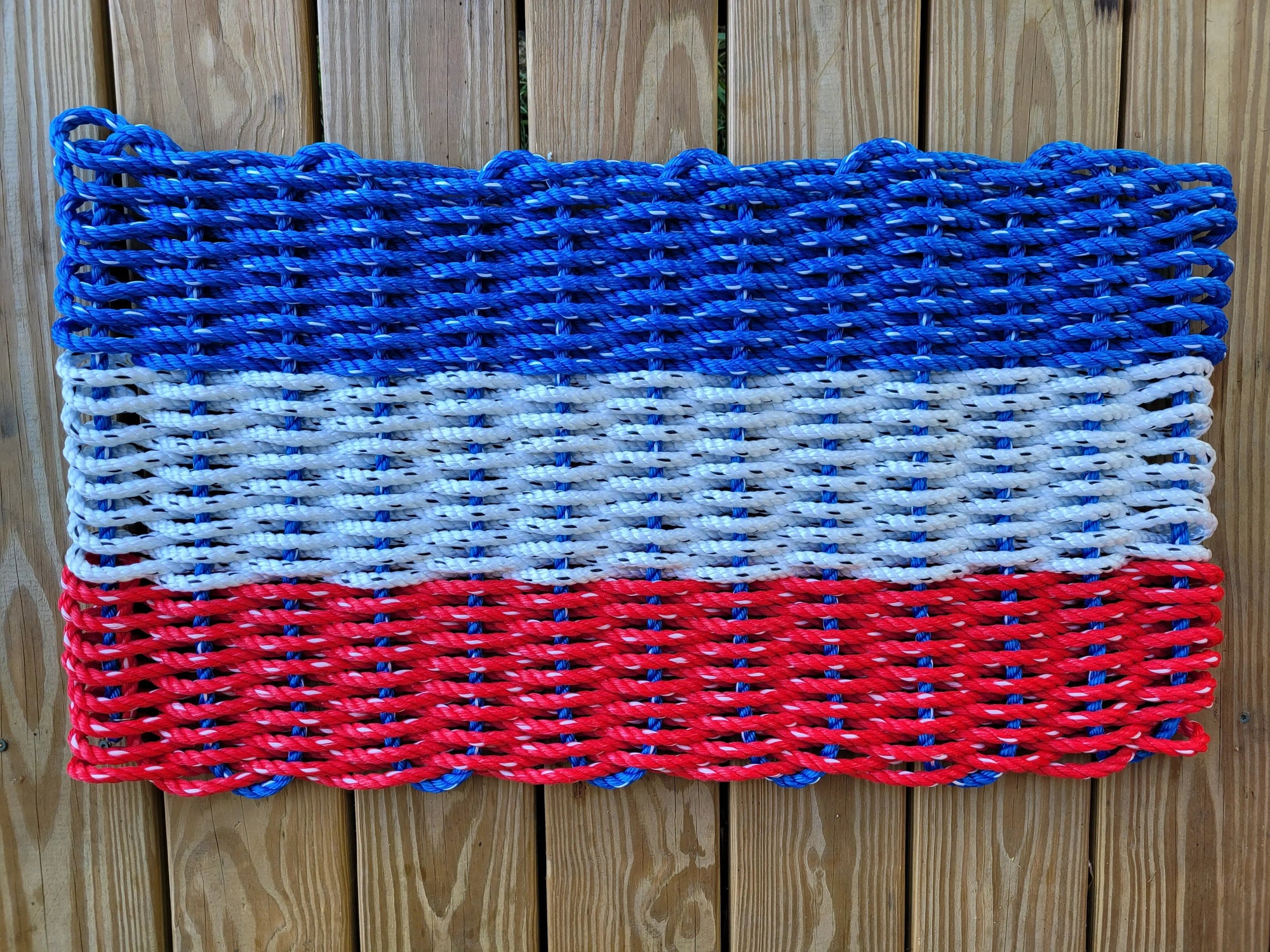 Red white and blue striped lobster rope mat handcrafted from authentic lobster rope