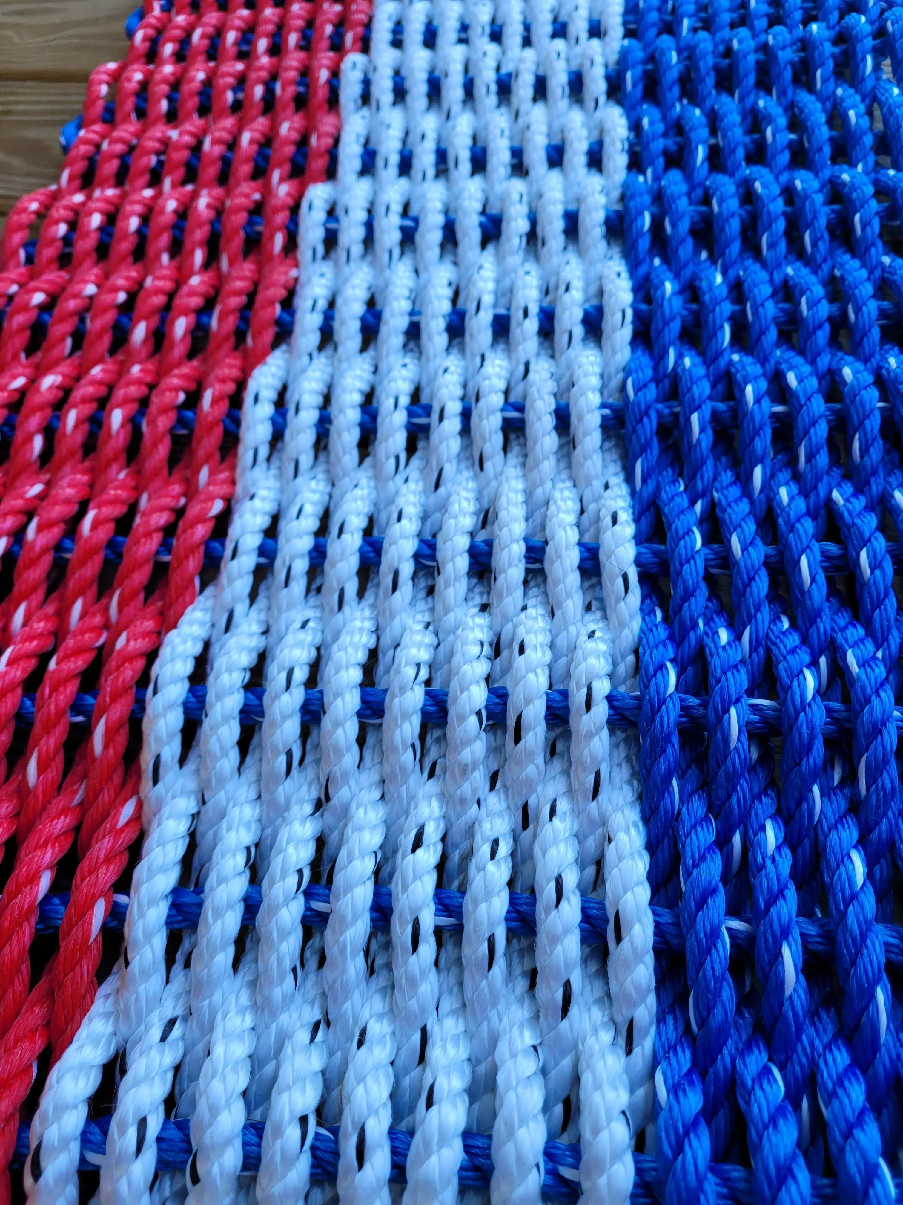Red white and blue striped lobster rope mat handcrafted from authentic lobster rope