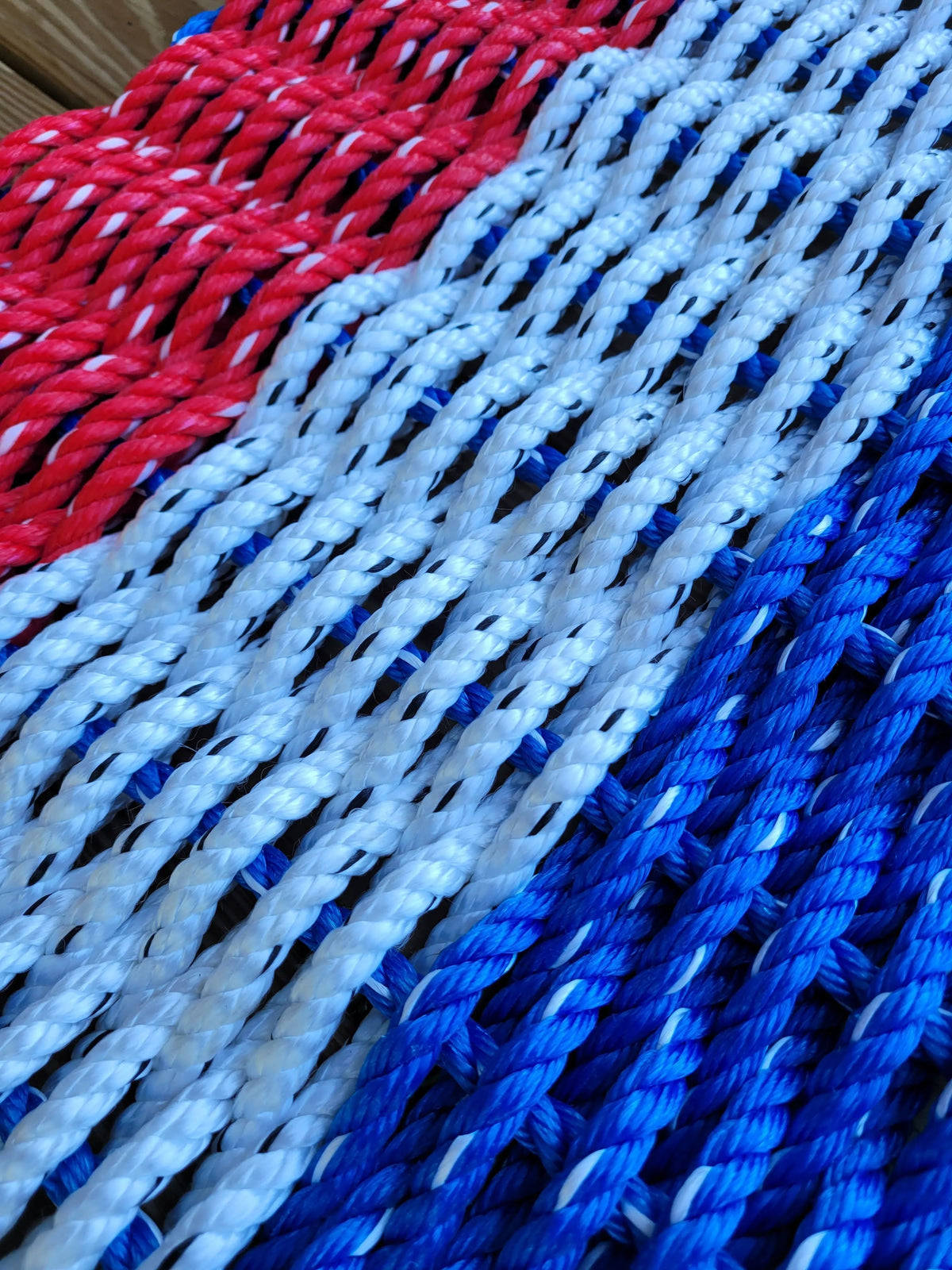 Red white and blue striped lobster rope mat handcrafted from authentic lobster rope