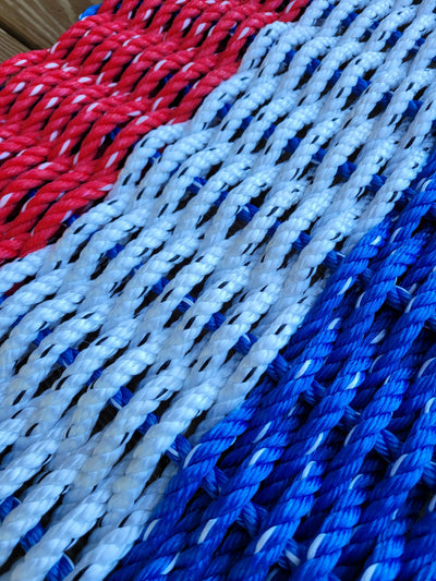 Red white and blue striped lobster rope mat handcrafted from authentic lobster rope