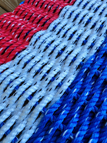 Red white and blue striped lobster rope mat handcrafted from authentic lobster rope