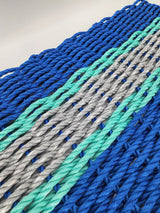 Handmade lobster rope door mat in blue, light gray, and teal accents