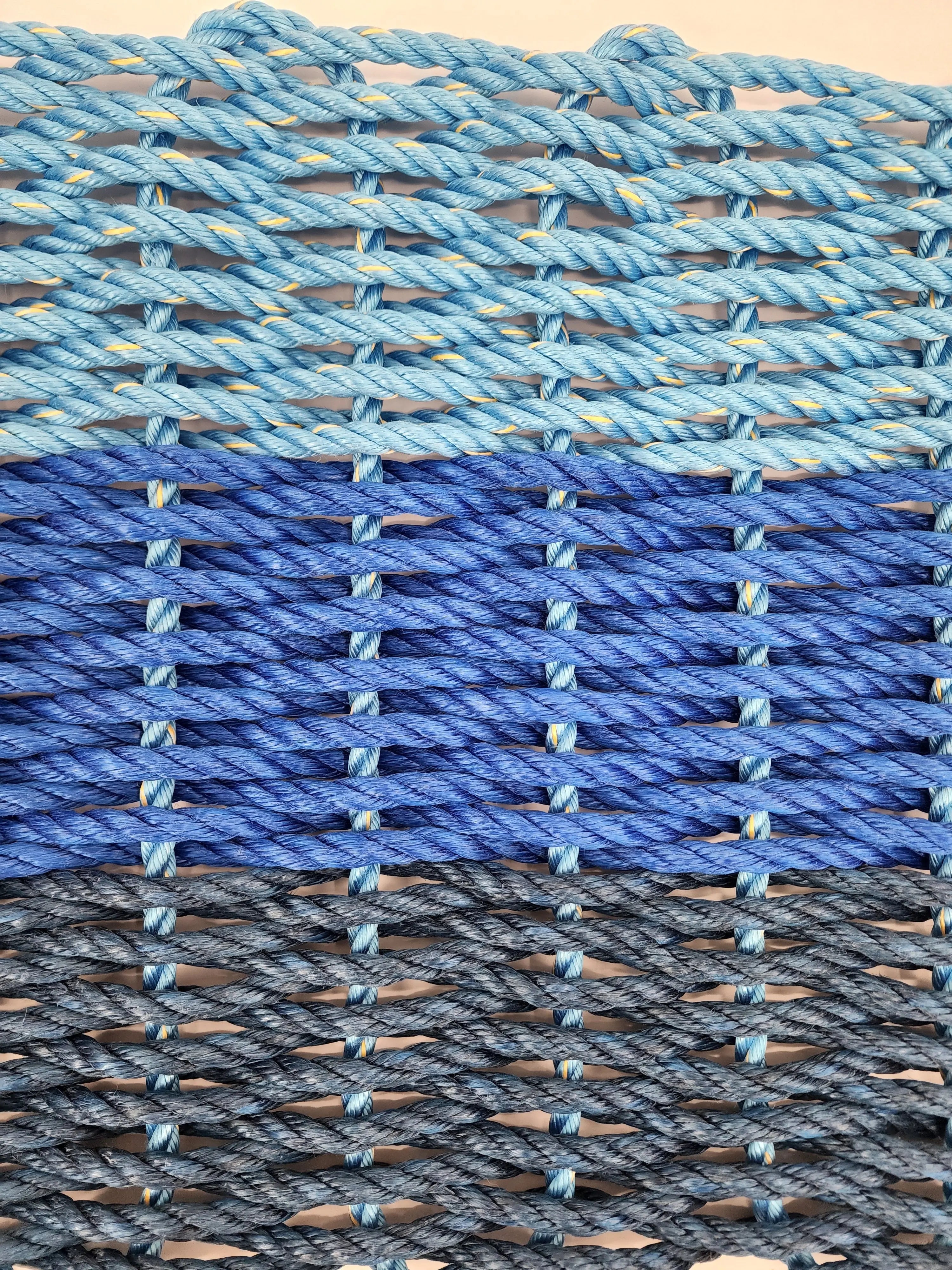 Handmade lobster rope mat in navy, royal, and light blue ombre colors