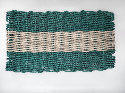 Hunter Green and Tan handmade lobster rope mat on wooden floor