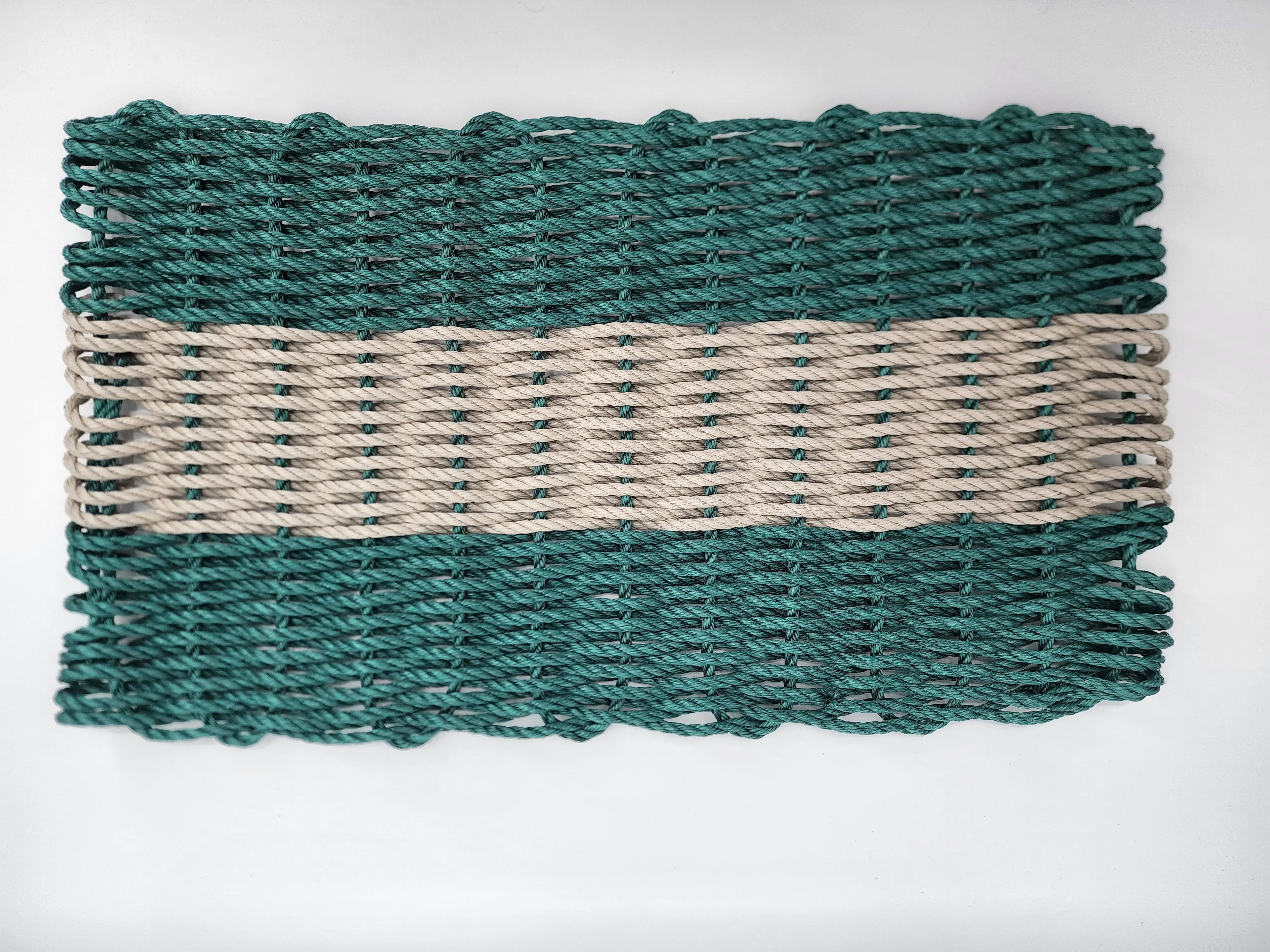 Hunter Green and Tan handmade lobster rope mat on wooden floor