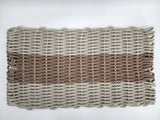 Handmade lobster rope mat in tan and brown colors, displayed on wooden floor