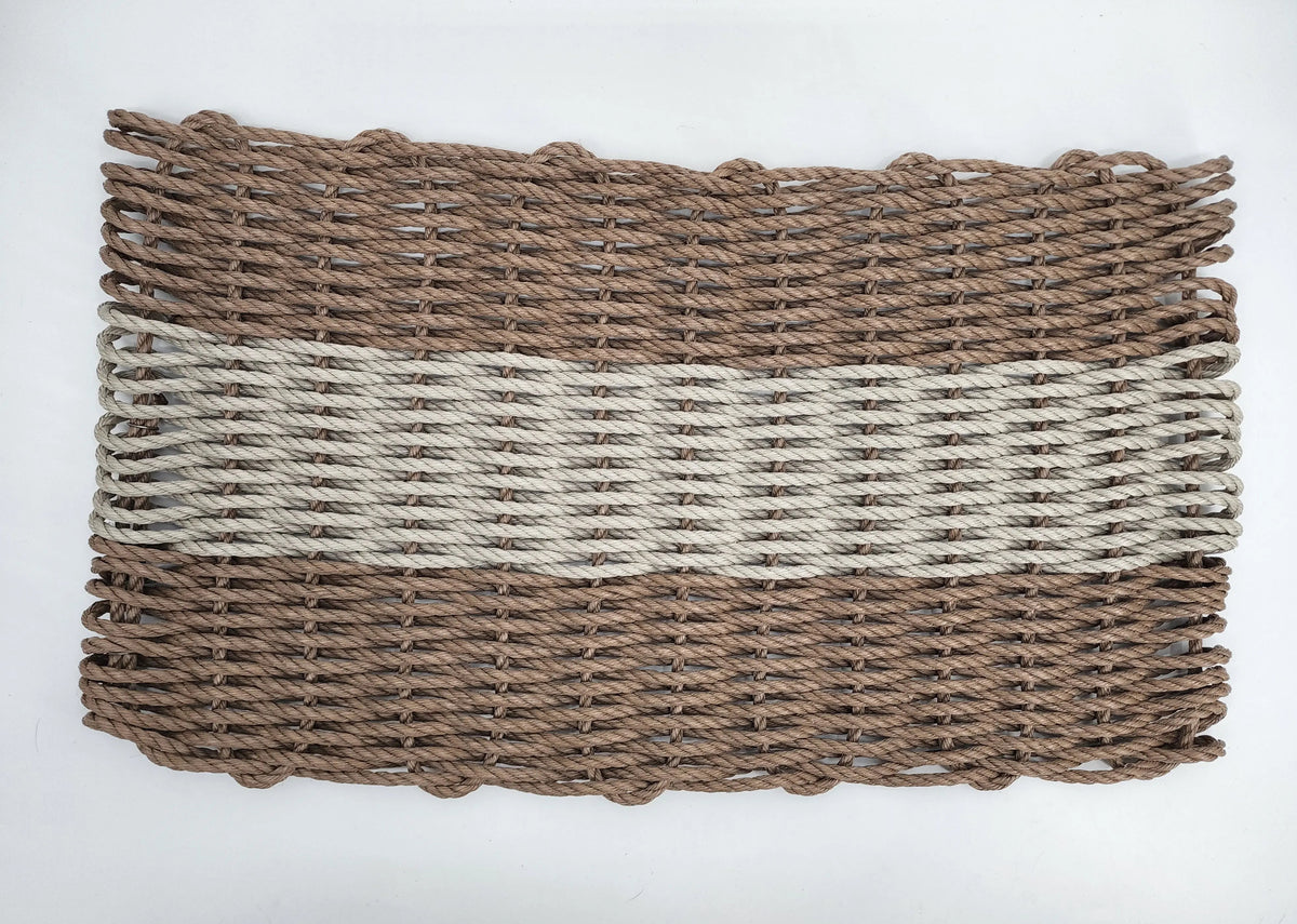 Handmade brown and tan lobster rope mat on wooden floor