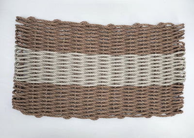 Handmade brown and tan lobster rope mat on wooden floor