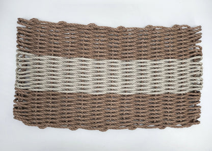 Handmade brown and tan lobster rope mat on wooden floor