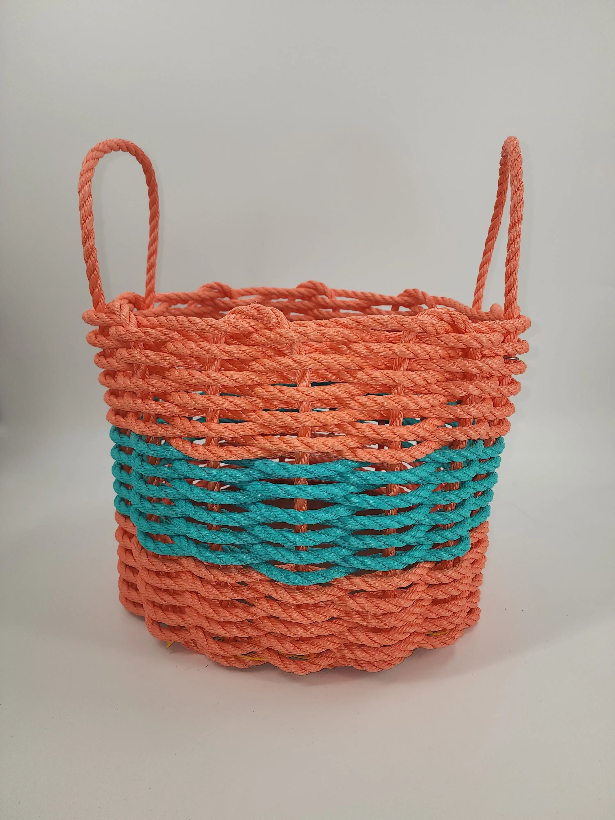 Handmade lobster rope storage basket in coral orange and teal colors