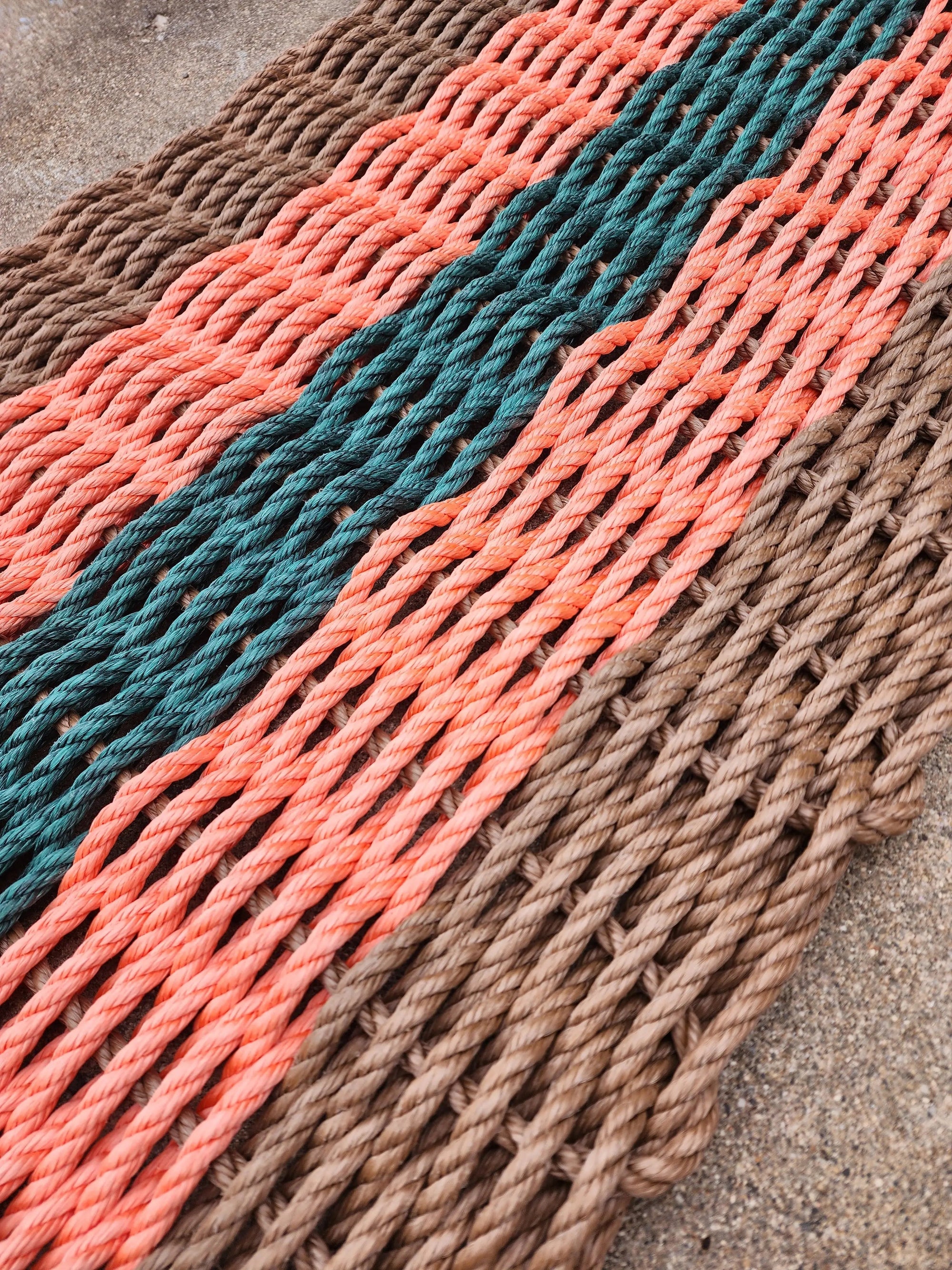 Brown, orange, and hunter green lobster rope door mat handmade on Maine coast