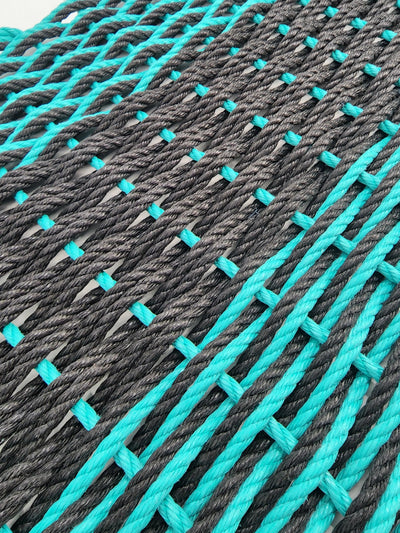 Large double weave lobster rope door mat in vibrant colors on porch