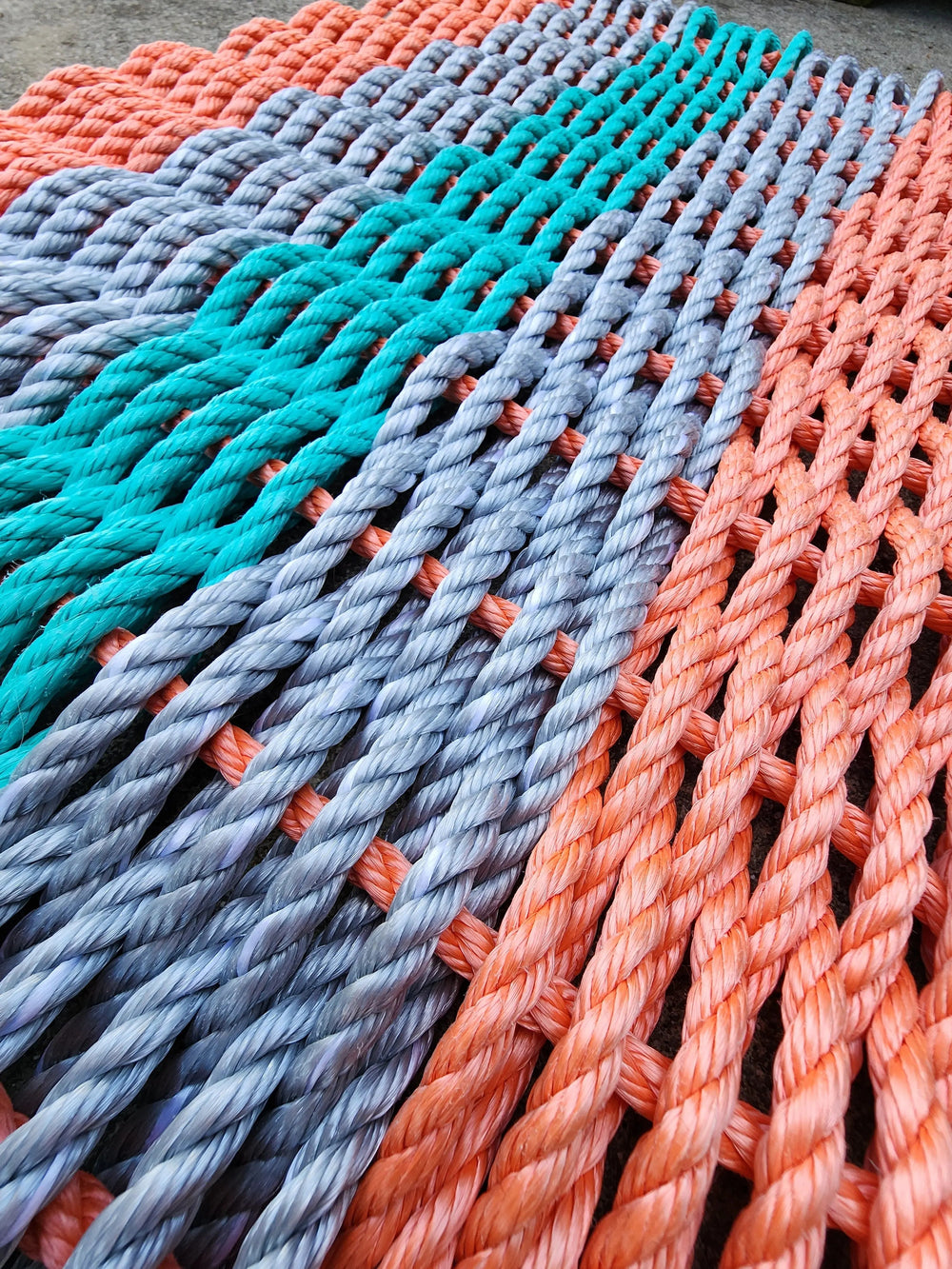 5 Stripe Lobster Rope Mat in coral orange, light gray, and teal colors