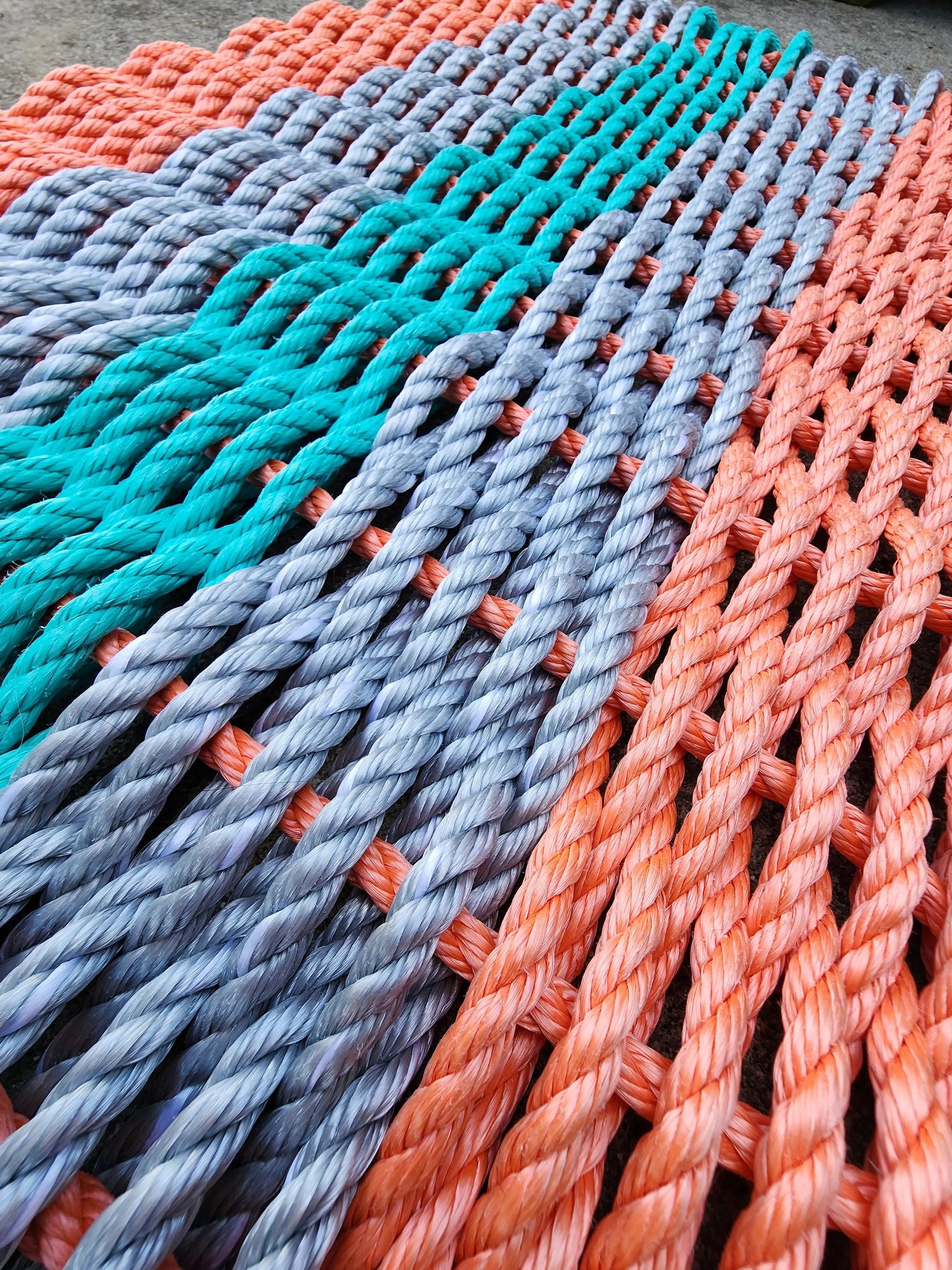 5 Stripe Lobster Rope Mat in coral orange, light gray, and teal colors