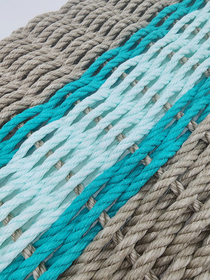 Handmade lobster rope door mat in tan with seafoam and navy blue accent colors