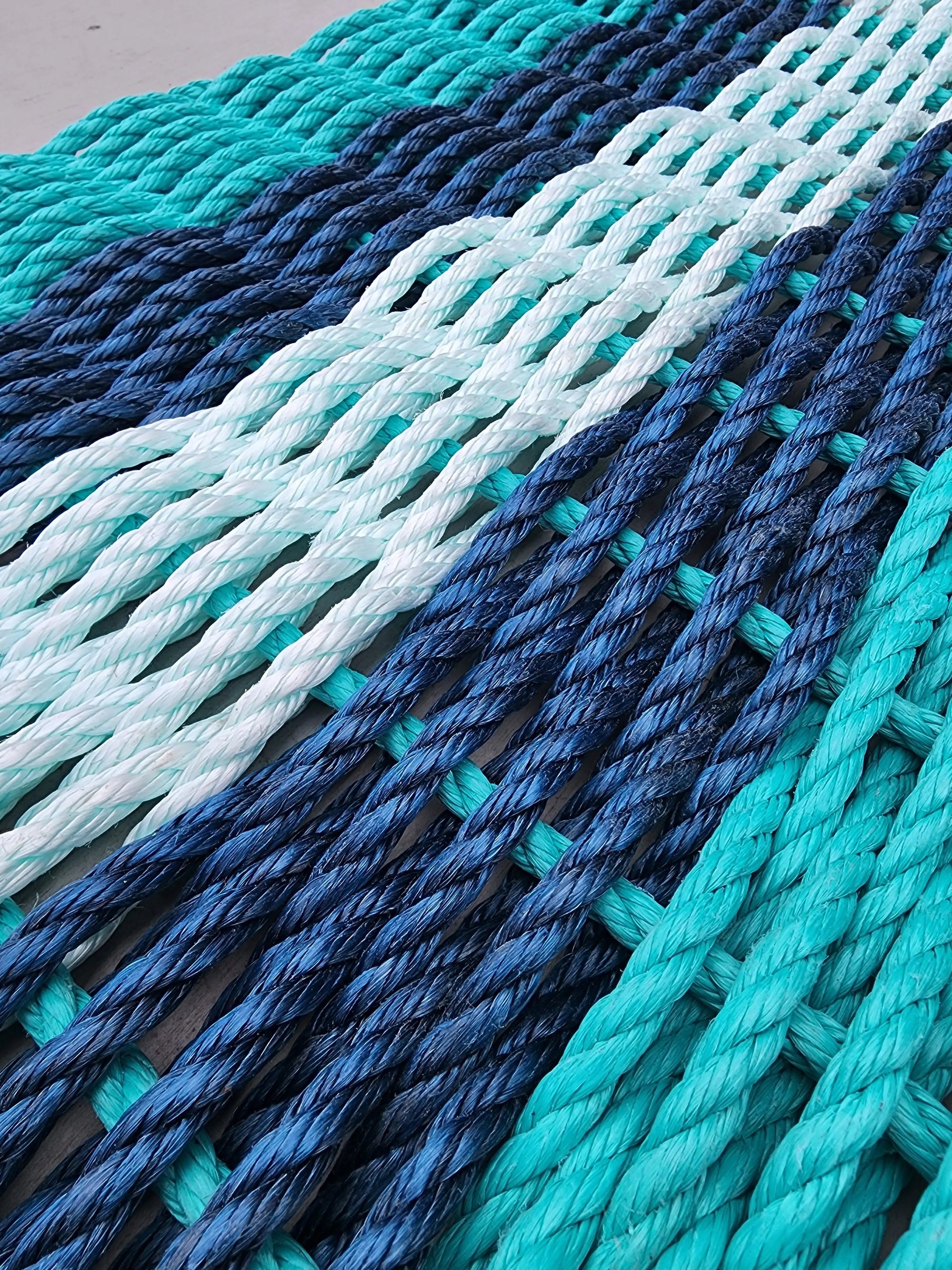 Handmade 5 Stripe Lobster Rope Mat in teal, navy blue, and seafoam colors