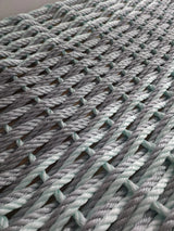 Large double weave lobster rope mat in light gray and seafoam colors
