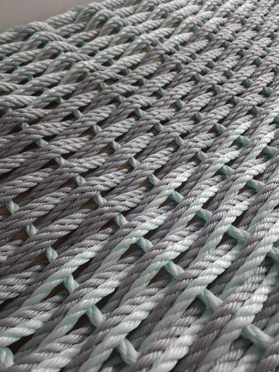 Large double weave lobster rope mat in light gray and seafoam colors
