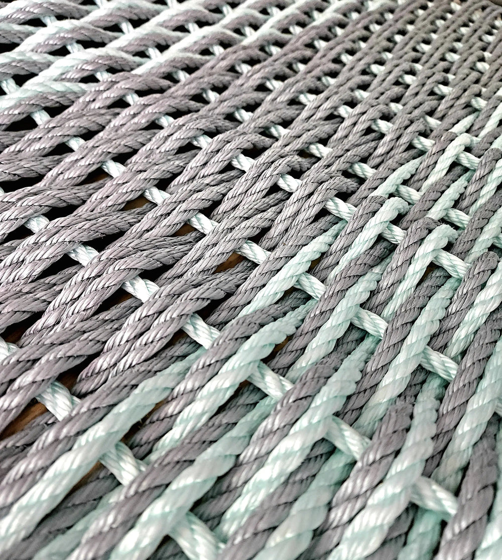 Large double weave lobster rope mat in light gray and seafoam colors