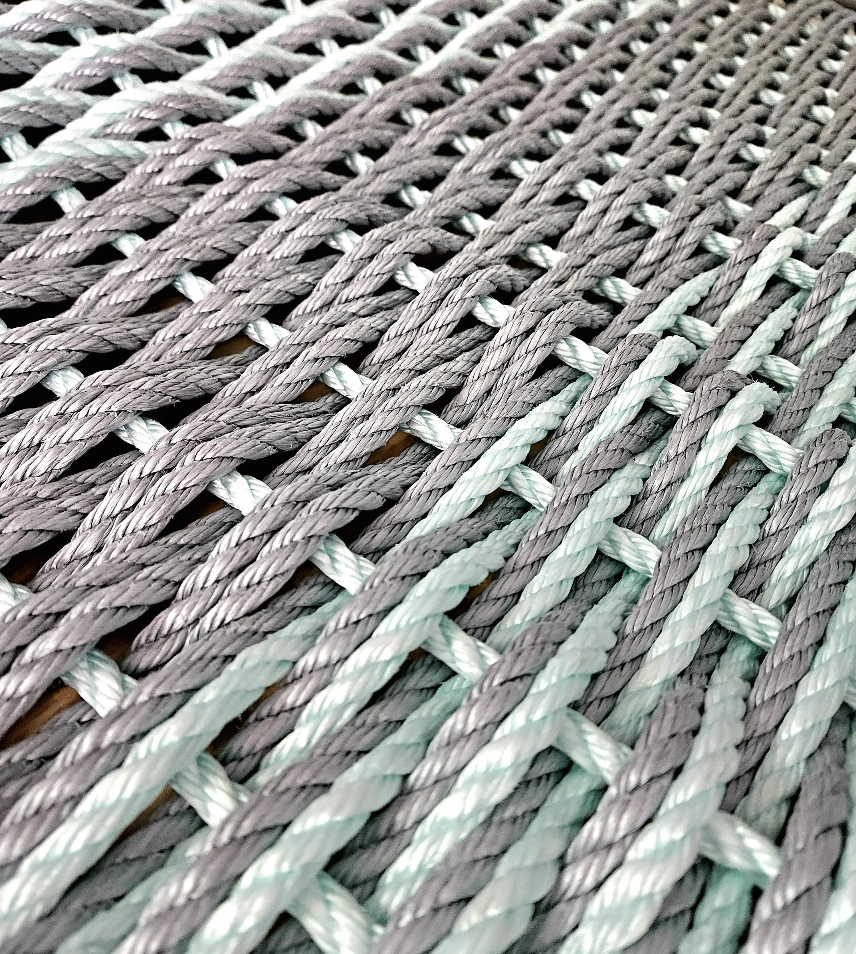 Large double weave lobster rope mat in light gray and seafoam colors