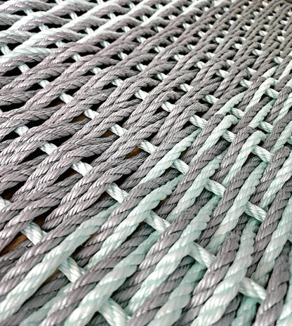 Large double weave lobster rope mat in light gray and seafoam colors