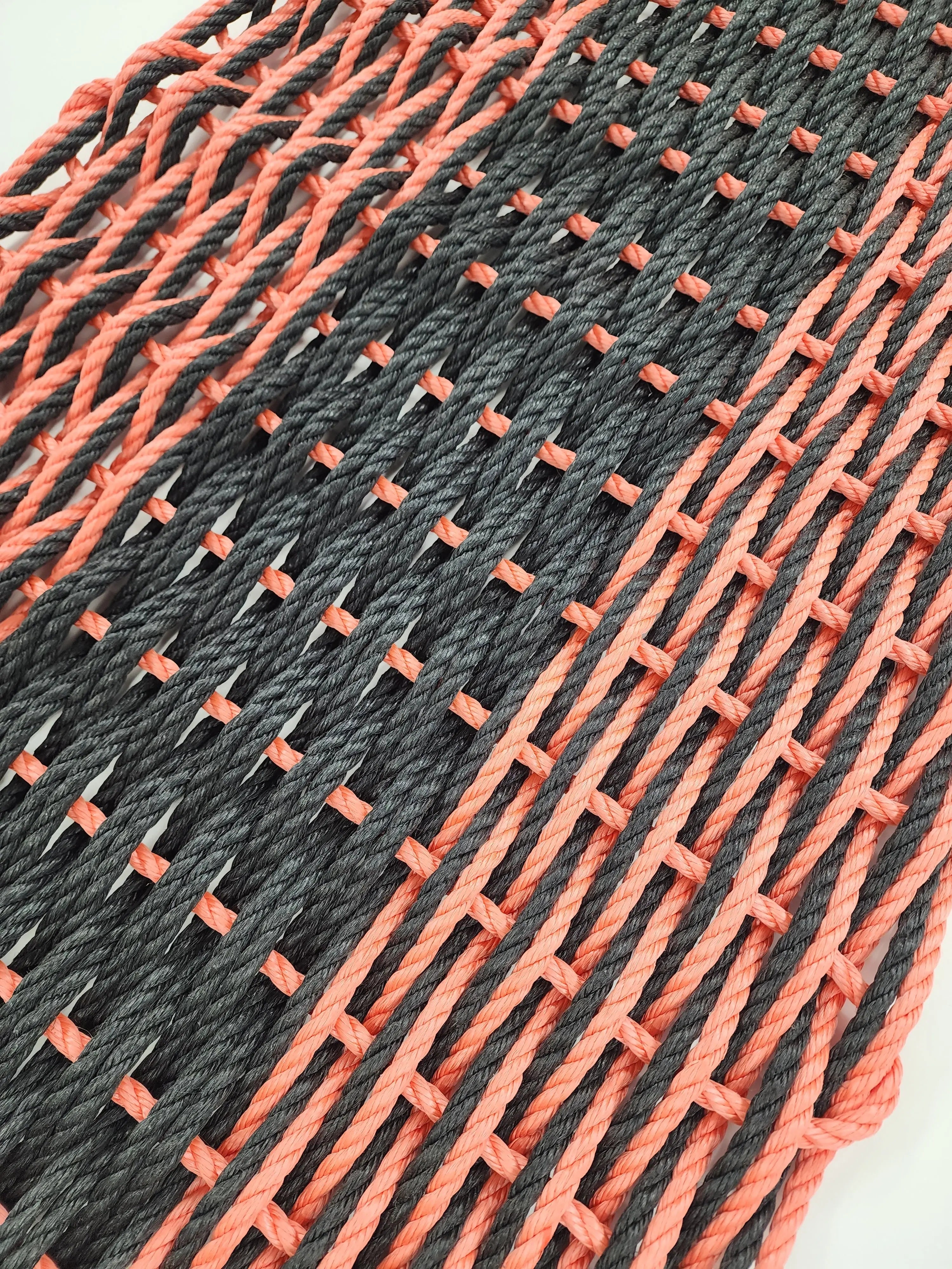 Large double weave lobster rope door mat in vibrant colors on porch