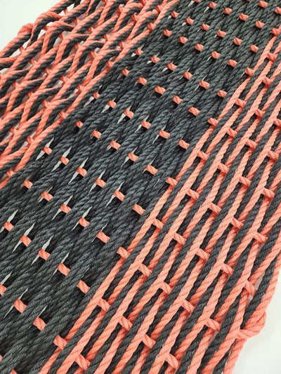 Large double weave lobster rope door mat in vibrant colors on porch