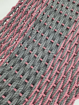 Large double weave lobster rope door mat in vibrant colors on porch
