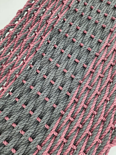 Large double weave lobster rope door mat in vibrant colors on porch