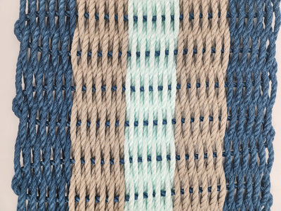 Five Stripe Rope Mat in navy, tan, and seafoam colors made from lobster rope