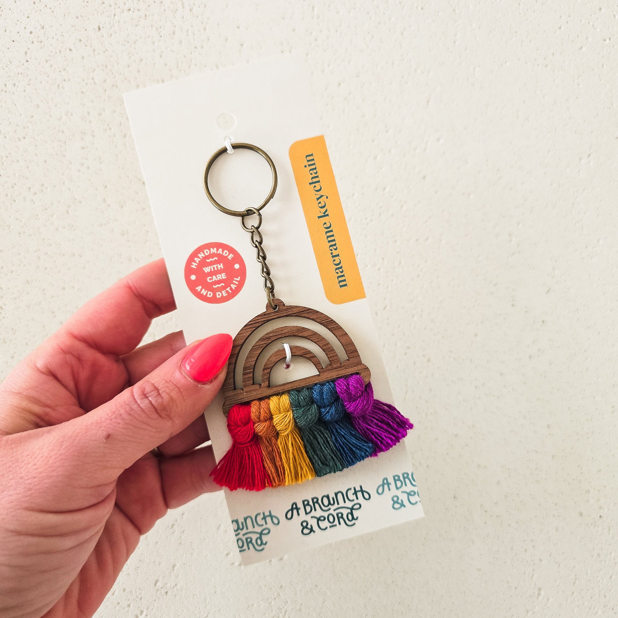 Wood Rainbow Keychain by A Branch & Cord showing colorful rainbow arches on wood with antique bronze key ring