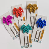 Bright and colorful macrame bookmark laid on wood surface