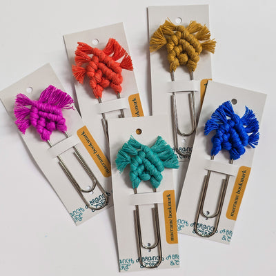Bright and colorful macrame bookmark laid on wood surface