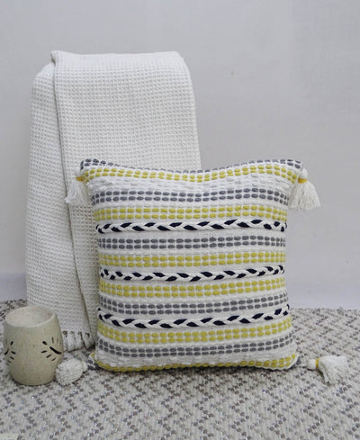 20 by 20 inches Throw Pillow with braided front and corner tassels on couch