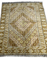Rectangular hand-knotted Afghani wool rug with diamond and geometric patterns in muted beige, brown, and cream tones and fringed edges.