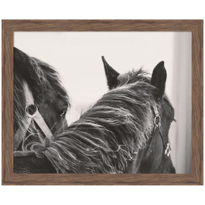 Framed Black Horses wall art print featuring two black horses in motion, shown in a room setting.