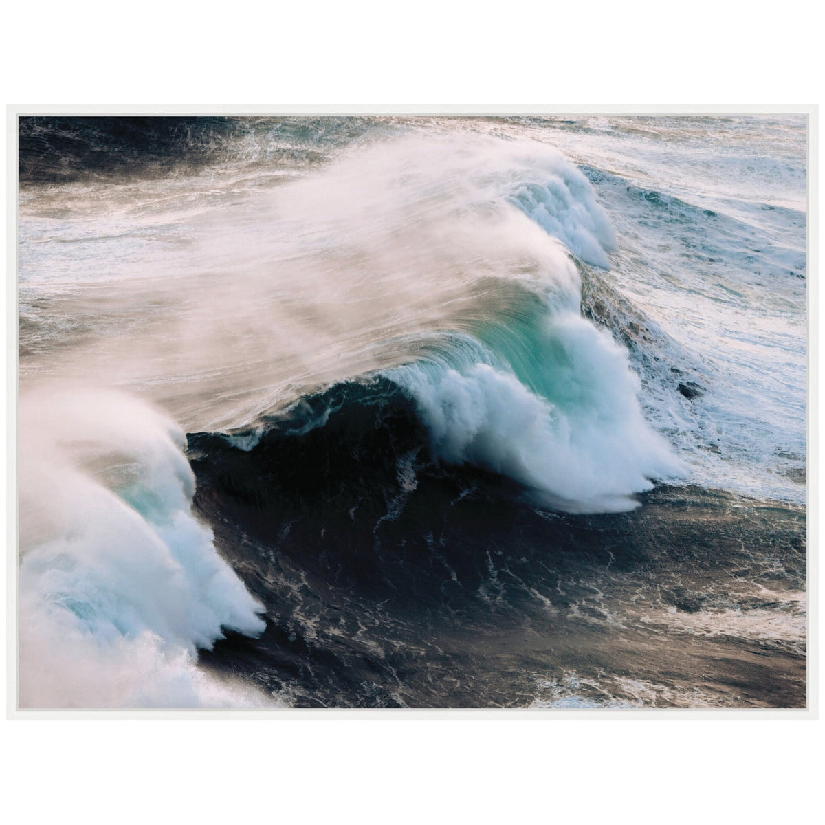 Dynamic crashing ocean waves along the Portuguese coast with white foam and mist swirling over deep blue water, captured in a framed canvas by Michael Schauer.