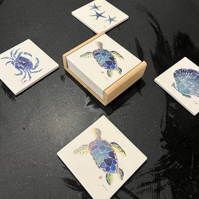 Sea Turtle Coaster set with detailed sea turtle design on a wood caddy holder, styled on a coastal-themed table