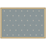 Rectangular pinboard with a muted blue fabric surface adorned with evenly spaced small beige botanical block print motifs, framed in light wood.